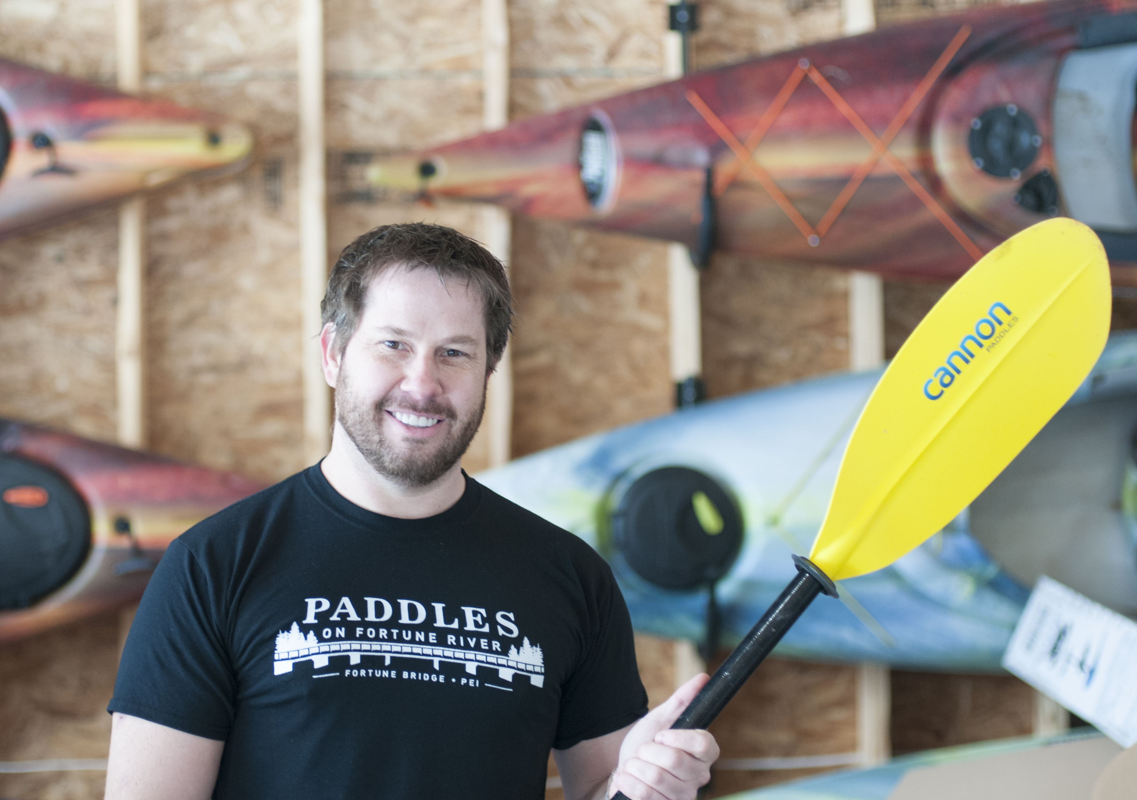 Image of man with paddle, recipient of Small Business Investment Grant