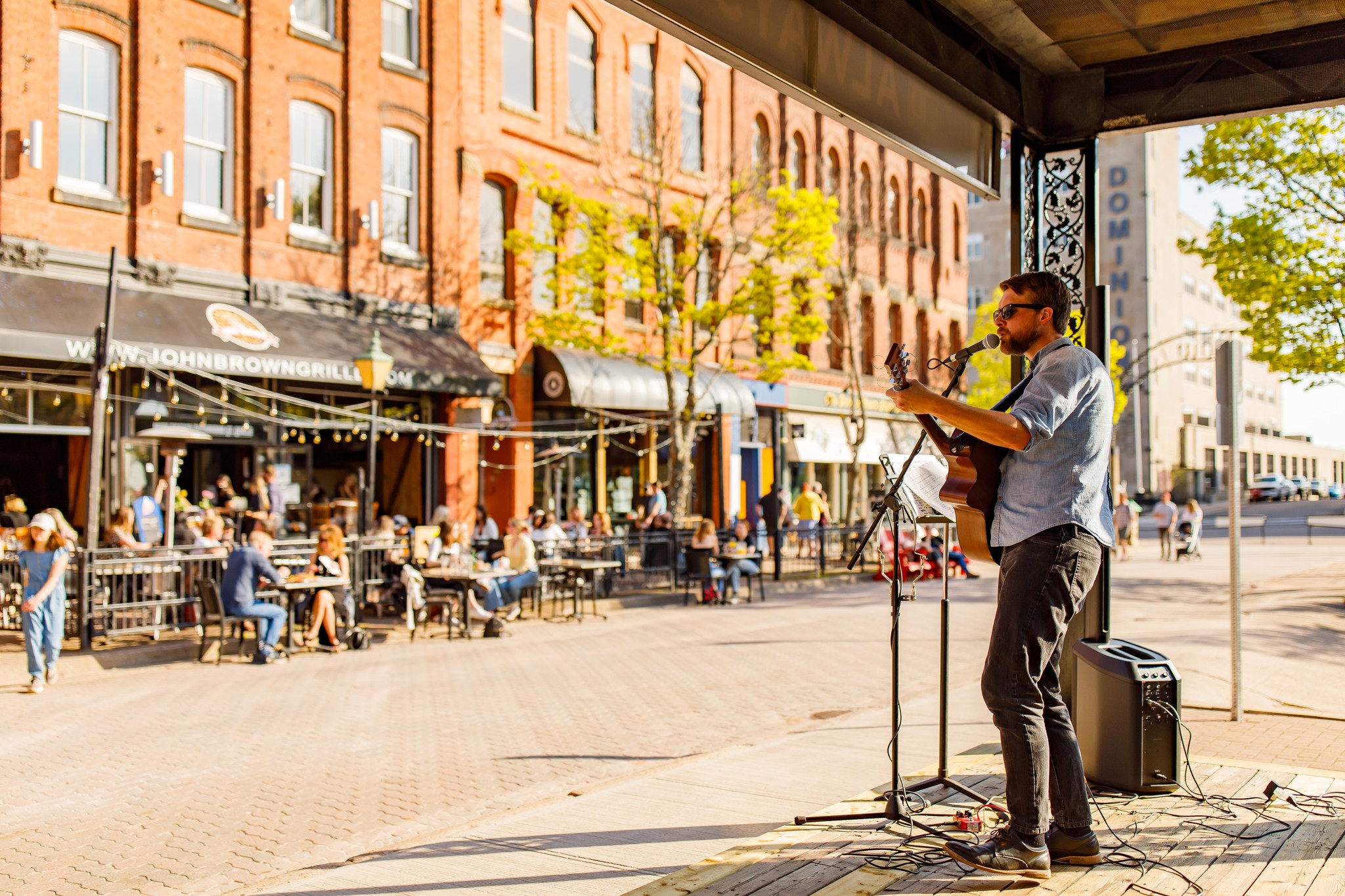 A musician performs on stage on Victoria Row, Charlottetown.